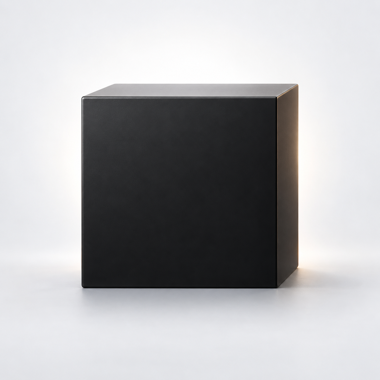 A minimal satin-black cube with soft light behind it